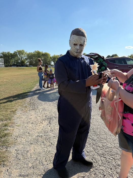 A costumed guest handing out treats at OYO's Trunk or Treat